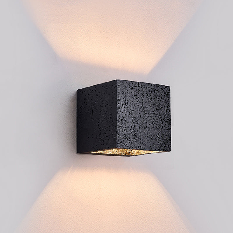 Black square wall light fixture on a gray wall