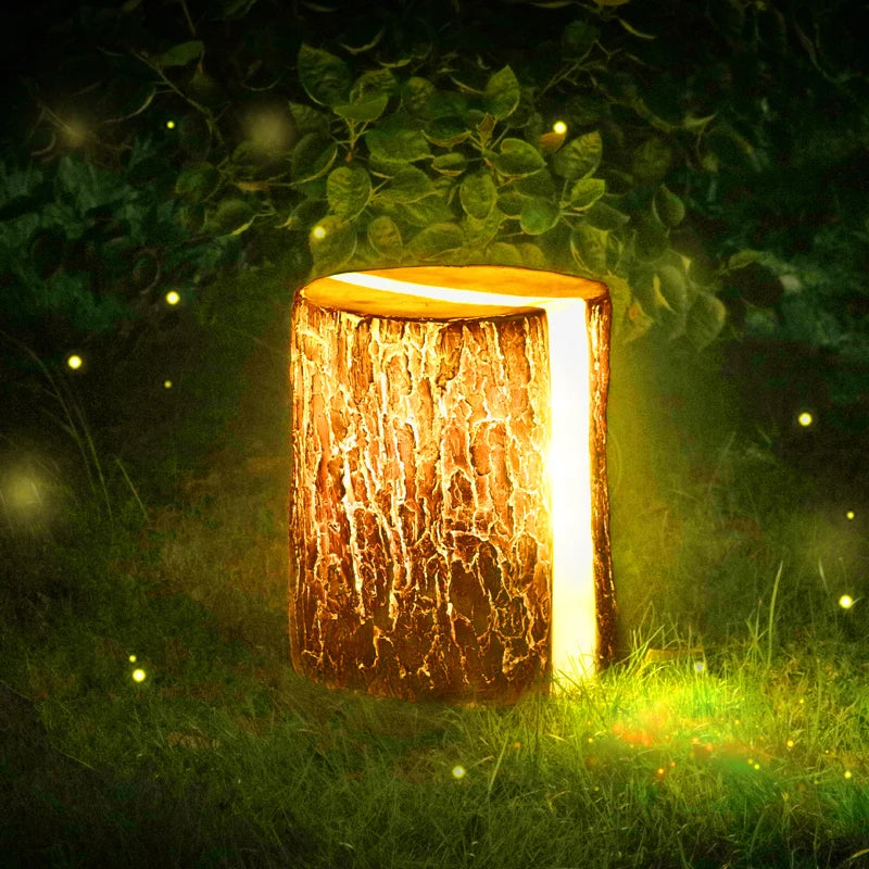 Wooden lantern-style LED stump lamp emitting warm light in a grassy outdoor setting