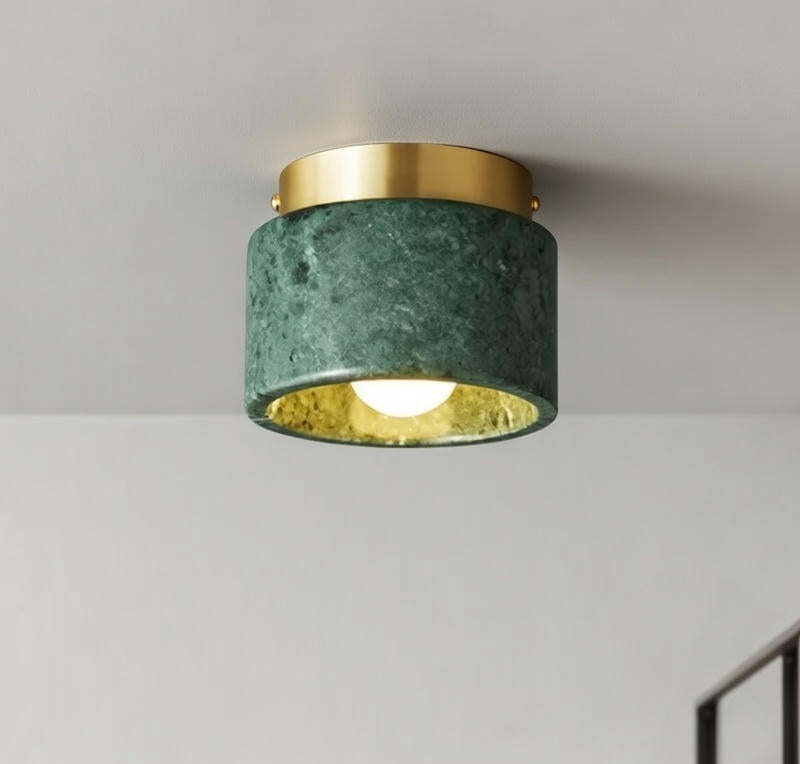 Ceiling light fixture with green marble-like shade and gold trim on a plain background
