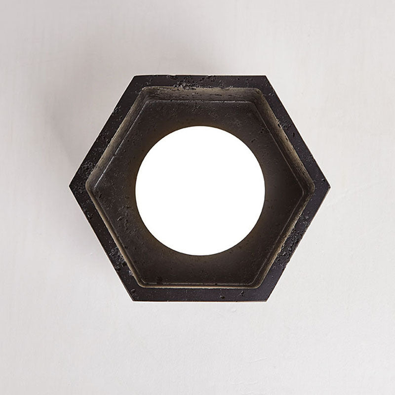 Hexagonal black light fixture on a white background