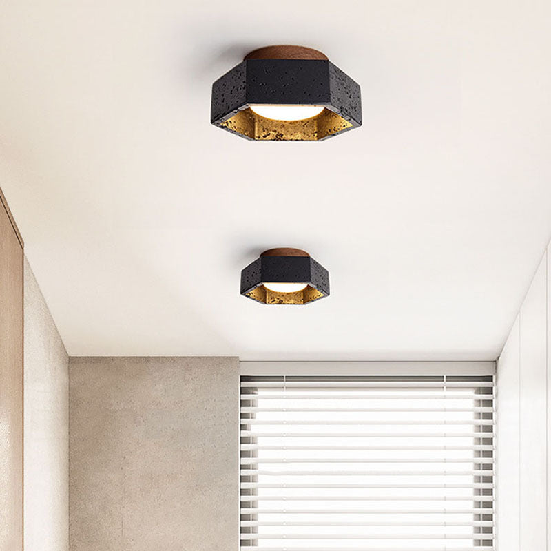 Two modern ceiling lights on a white ceiling with a window in the background.