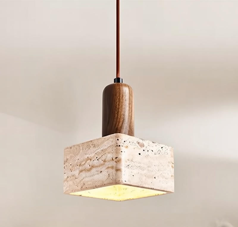 Pendant light with wooden fixture and marble-like shade on a neutral background