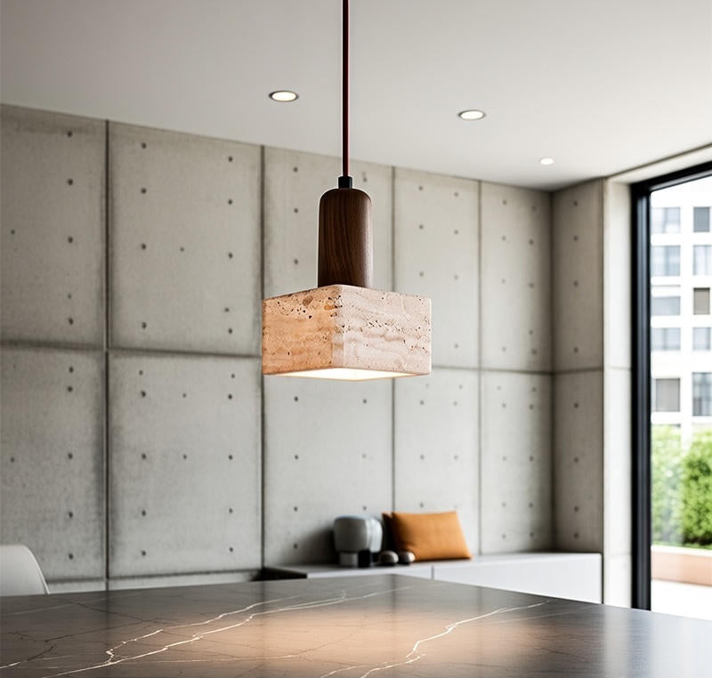 Modern interior with a pendant light hanging over a marble countertop.
